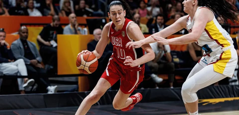 USA player dribbling past defender during basketball game