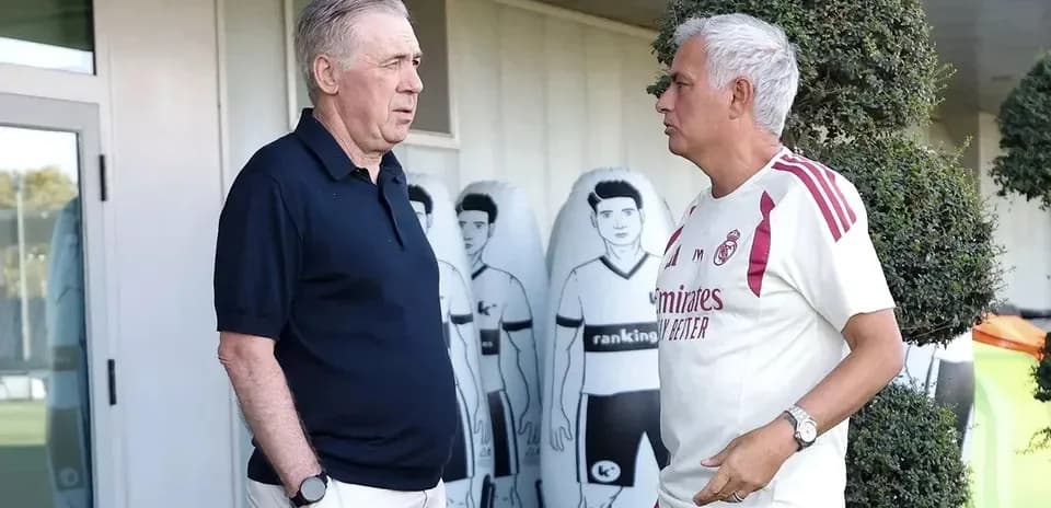 Two coaches discussing near training equipment