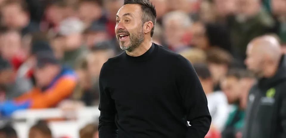 Manager coaching during a match with spectators behind