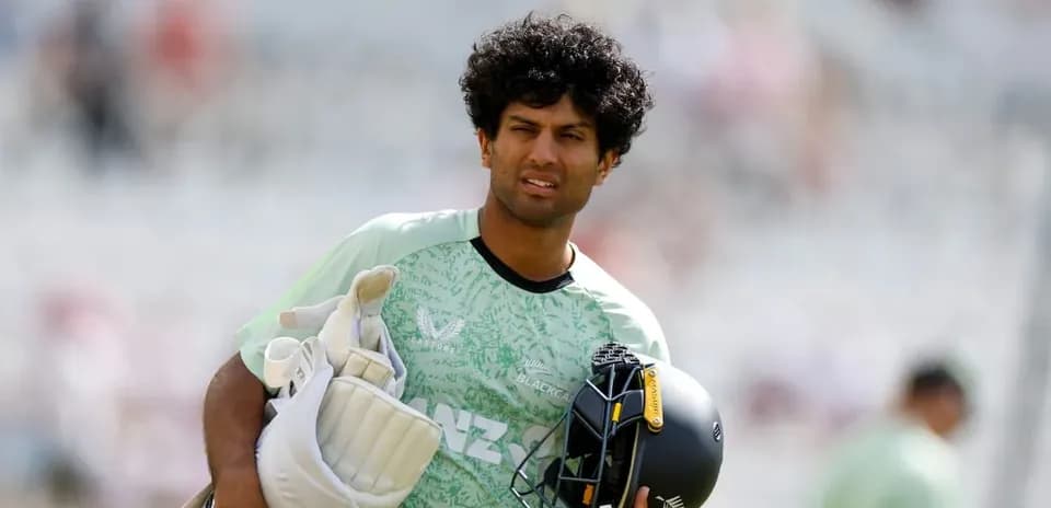 Cricketer carrying gear during warm-up session