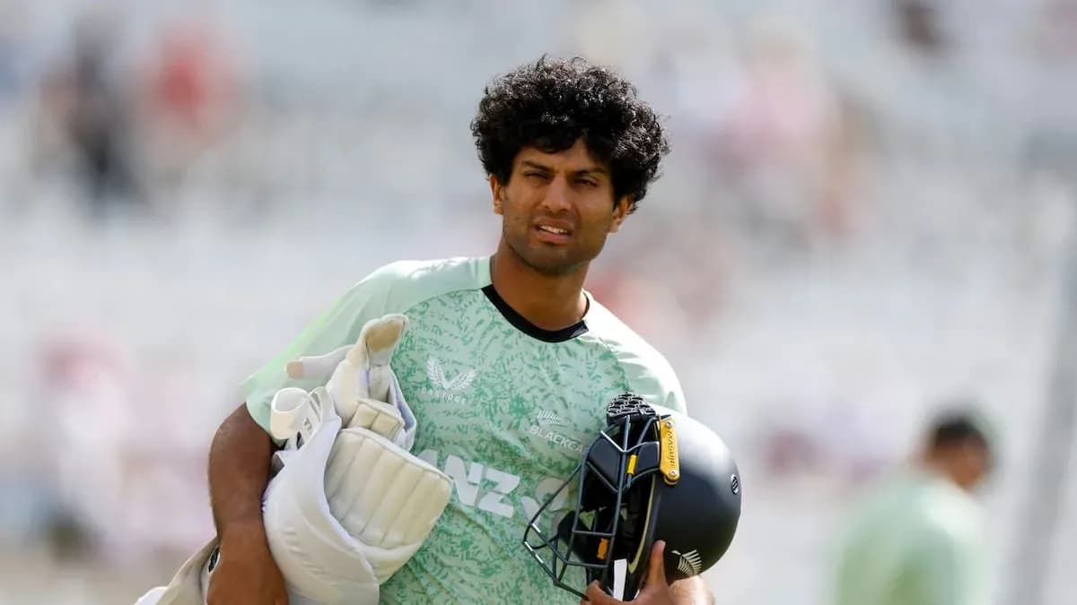 Cricketer carrying gear during warm-up session