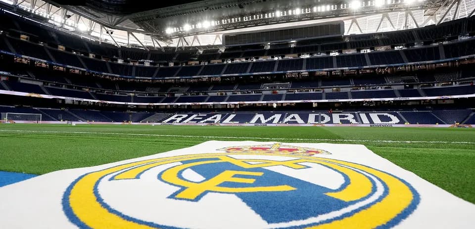 Real Madrid logo on pitch at stadium interior
