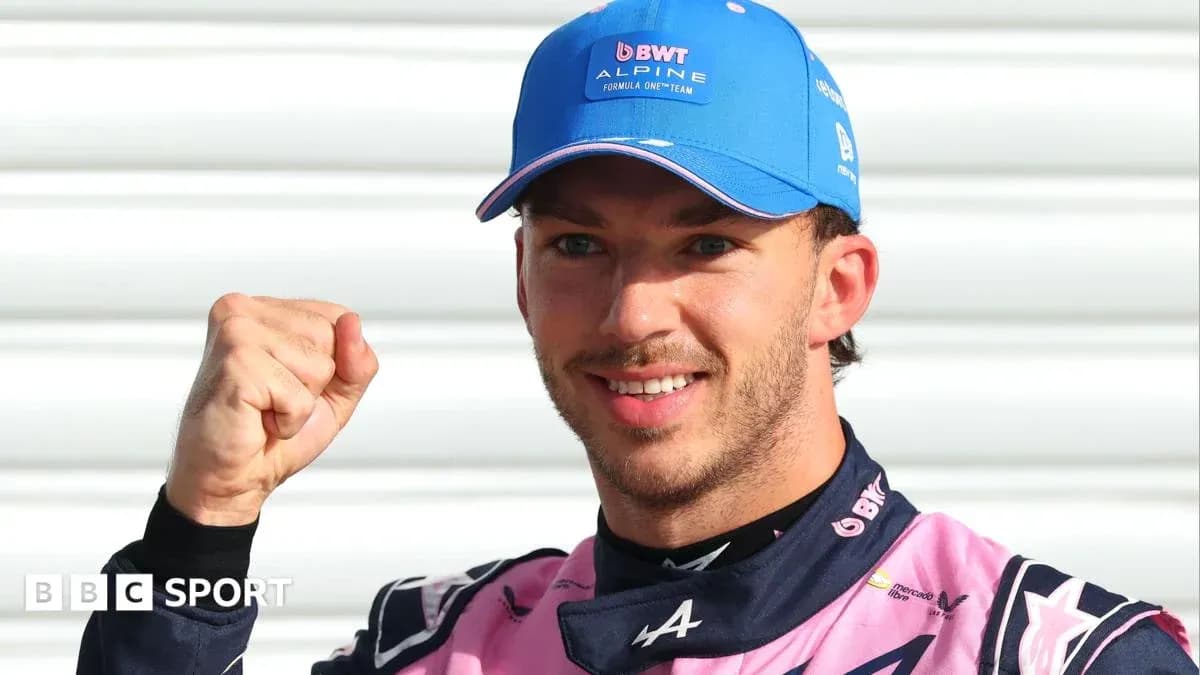 Driver celebrating with a raised fist in paddock Driver celebrating with a raised fist in paddock