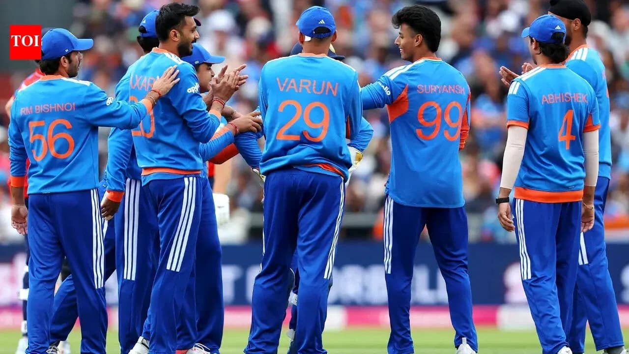 Cricket team celebrating a wicket on the field Cricket team celebrating a wicket on the field