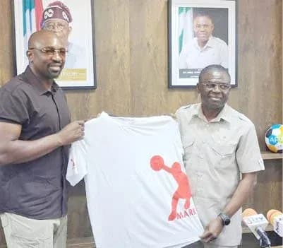 Two men holding a promotional t-shirt in office Two men holding a promotional t-shirt in office