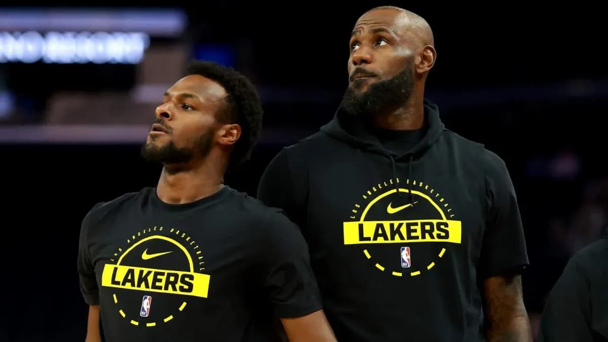 Two Lakers players in warm-up gear on court Two Lakers players in warm-up gear on court