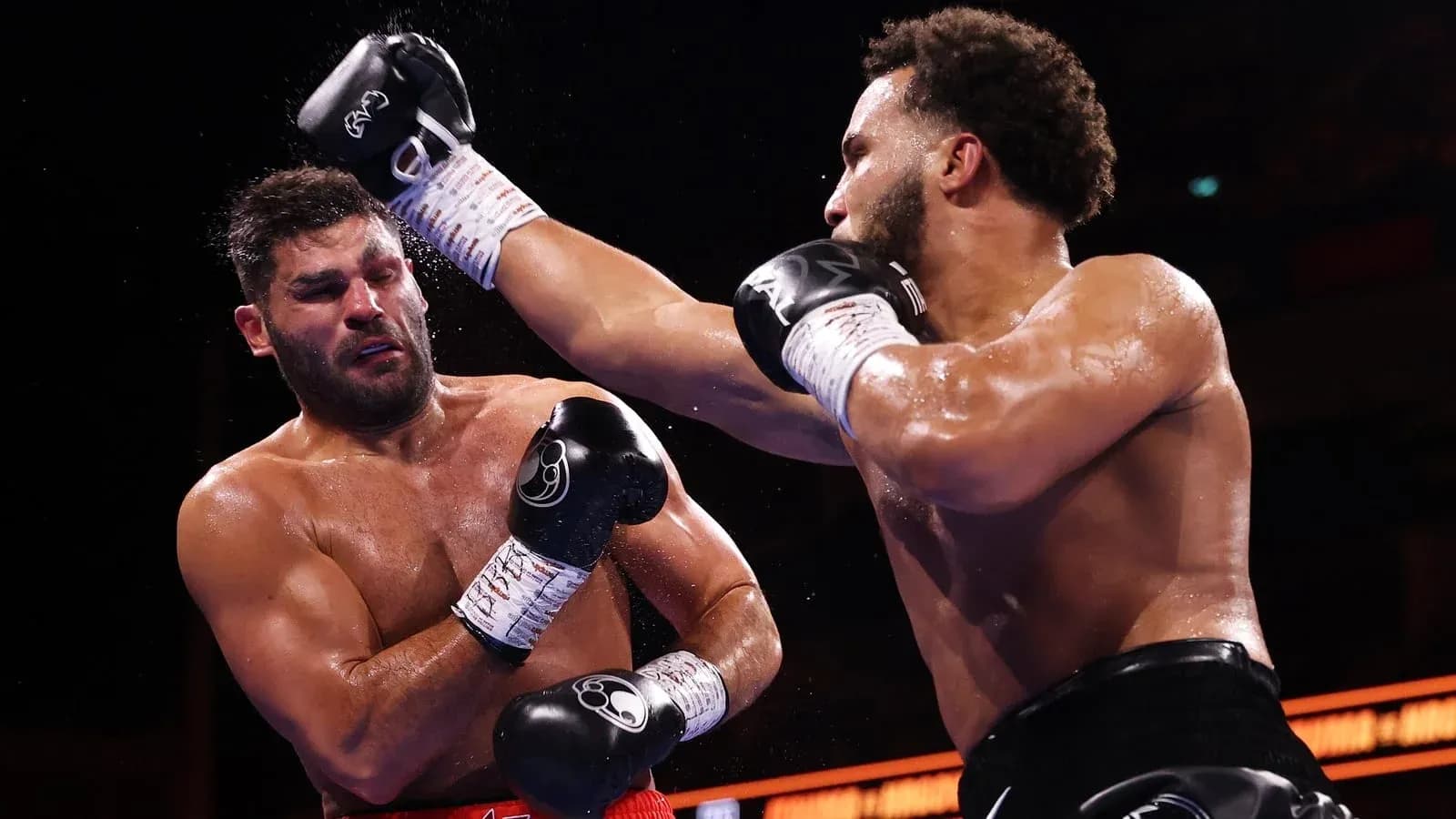 Boxers exchanging punches in a boxing match Boxers exchanging punches in a boxing match