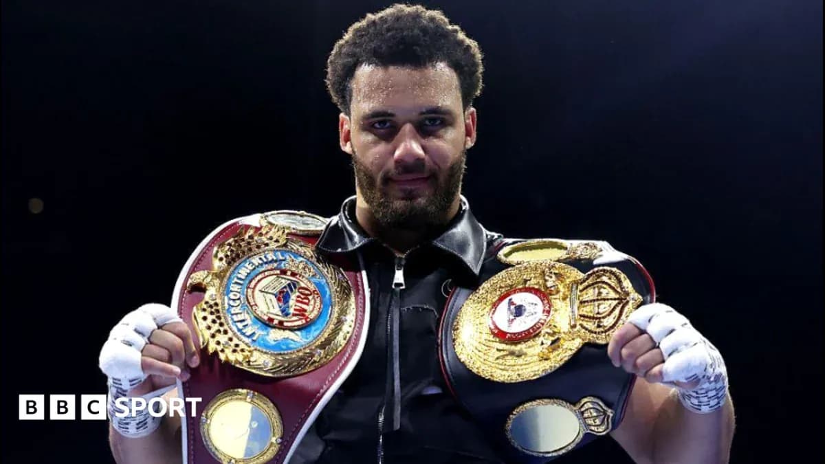 Boxer holding multiple championship belts in ring Boxer holding multiple championship belts in ring