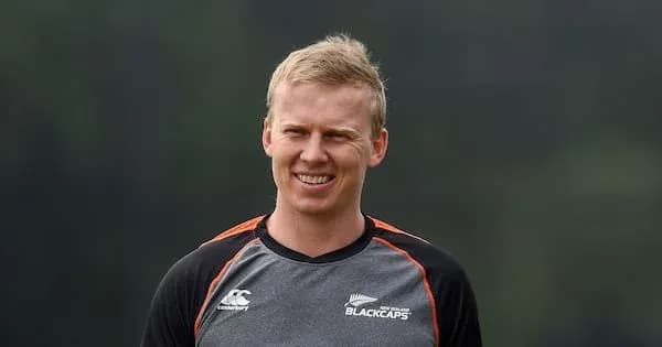 Cricketer smiling during training session outdoors Cricketer smiling during training session outdoors