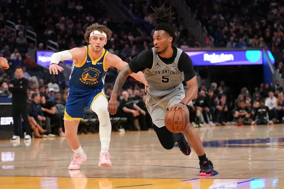 San Antonio player dribbling while pursued by Golden State defender San Antonio player dribbling while pursued by Golden State defender