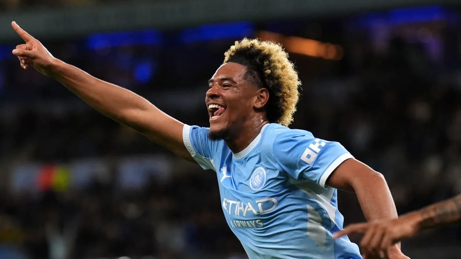 Player celebrating after scoring a goal for Manchester City Player celebrating after scoring a goal for Manchester City