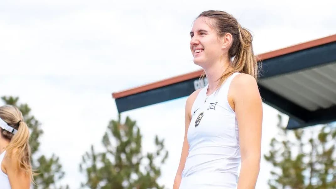 Tennis player smiling during outdoor event Tennis player smiling during outdoor event