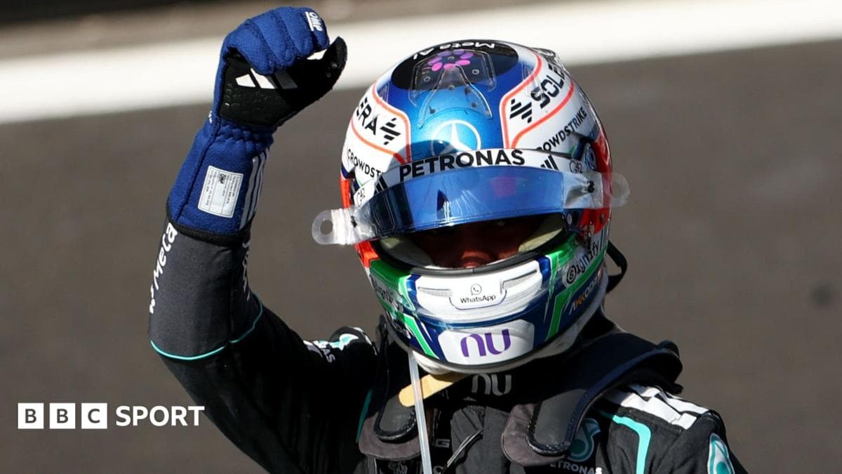 Driver celebrating with raised fist in racing gear Driver celebrating with raised fist in racing gear