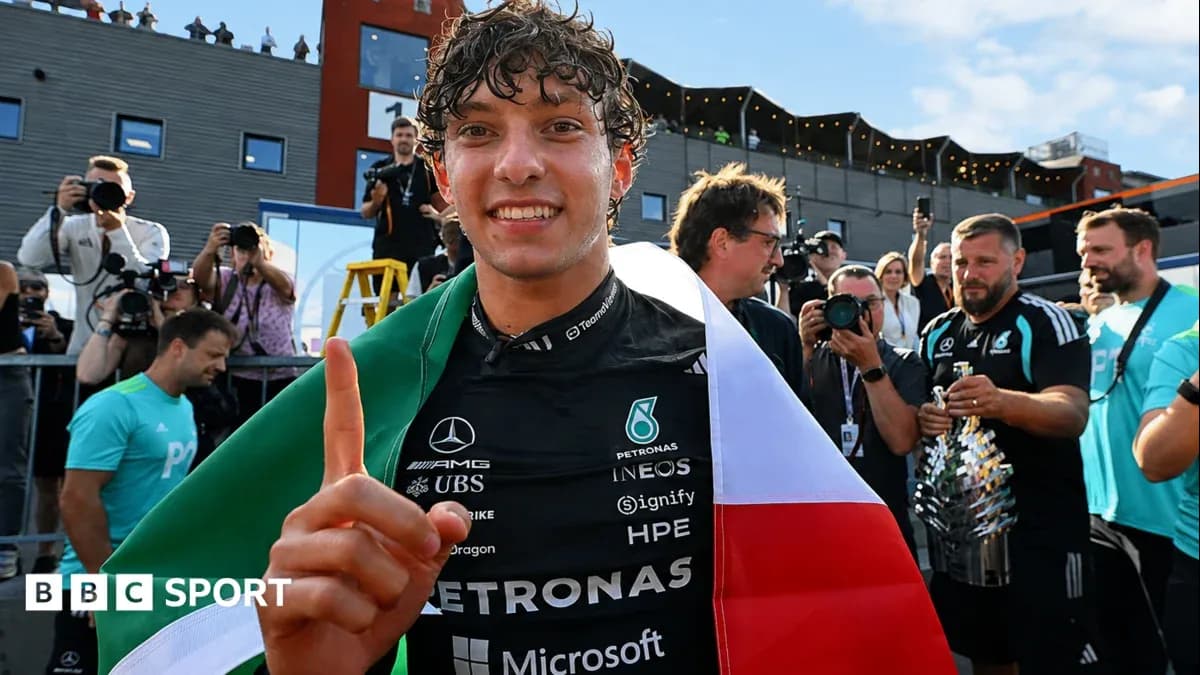 Driver celebrating with Italian flag after race victory Driver celebrating with Italian flag after race victory