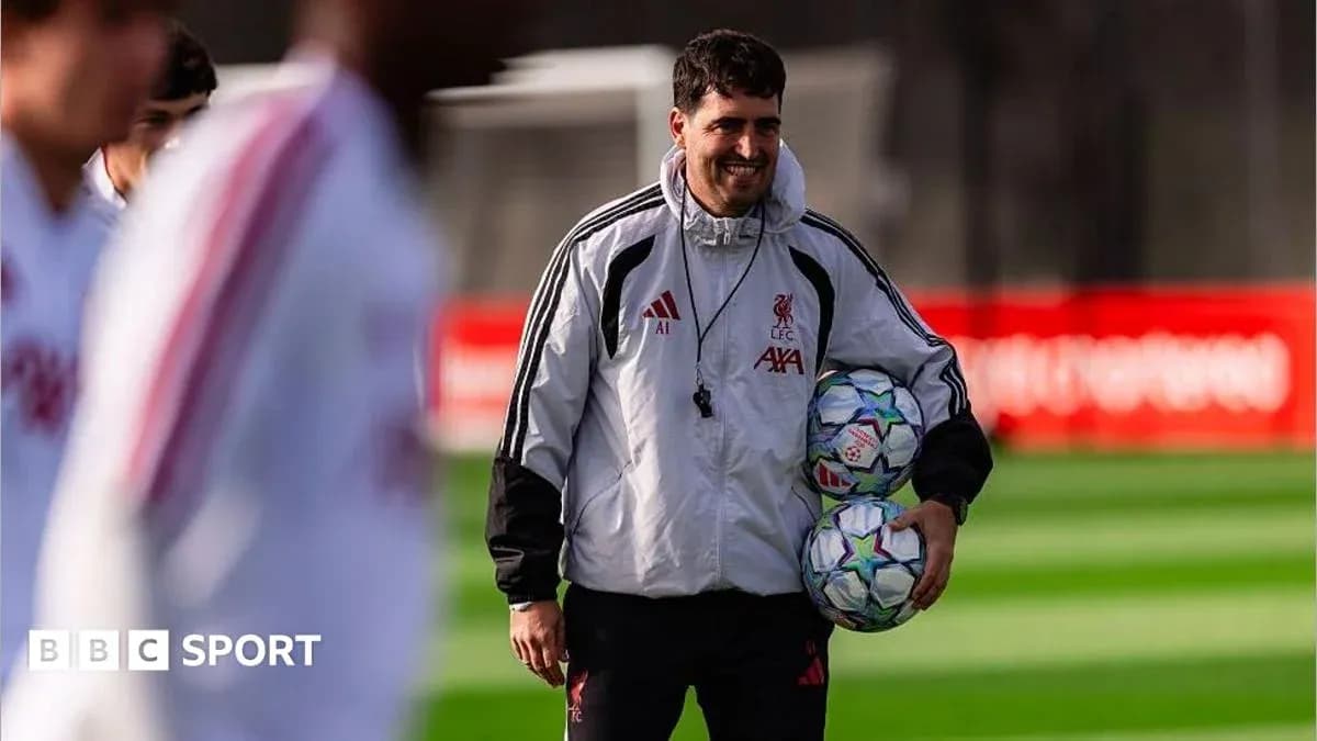 Coach holding footballs during training session Coach holding footballs during training session