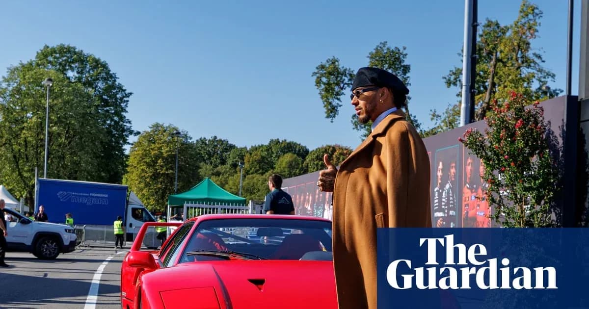 Person beside red sports car at event Person beside red sports car at event