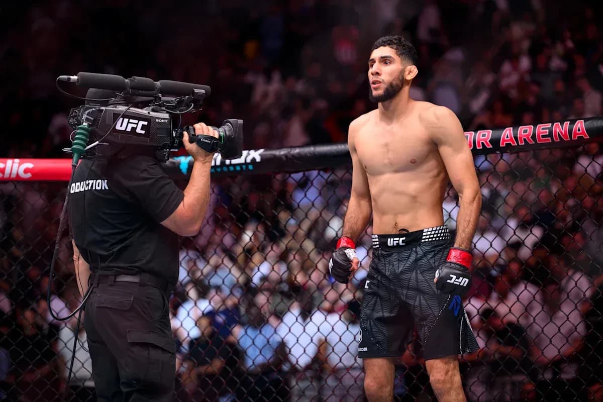 Fighter preparing for match inside UFC octagon Fighter preparing for match inside UFC octagon