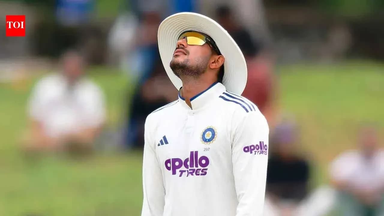 Cricketer looking up while fielding during match Cricketer looking up while fielding during match