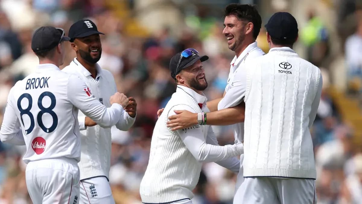 England cricket team celebrating a wicket on field England cricket team celebrating a wicket on field