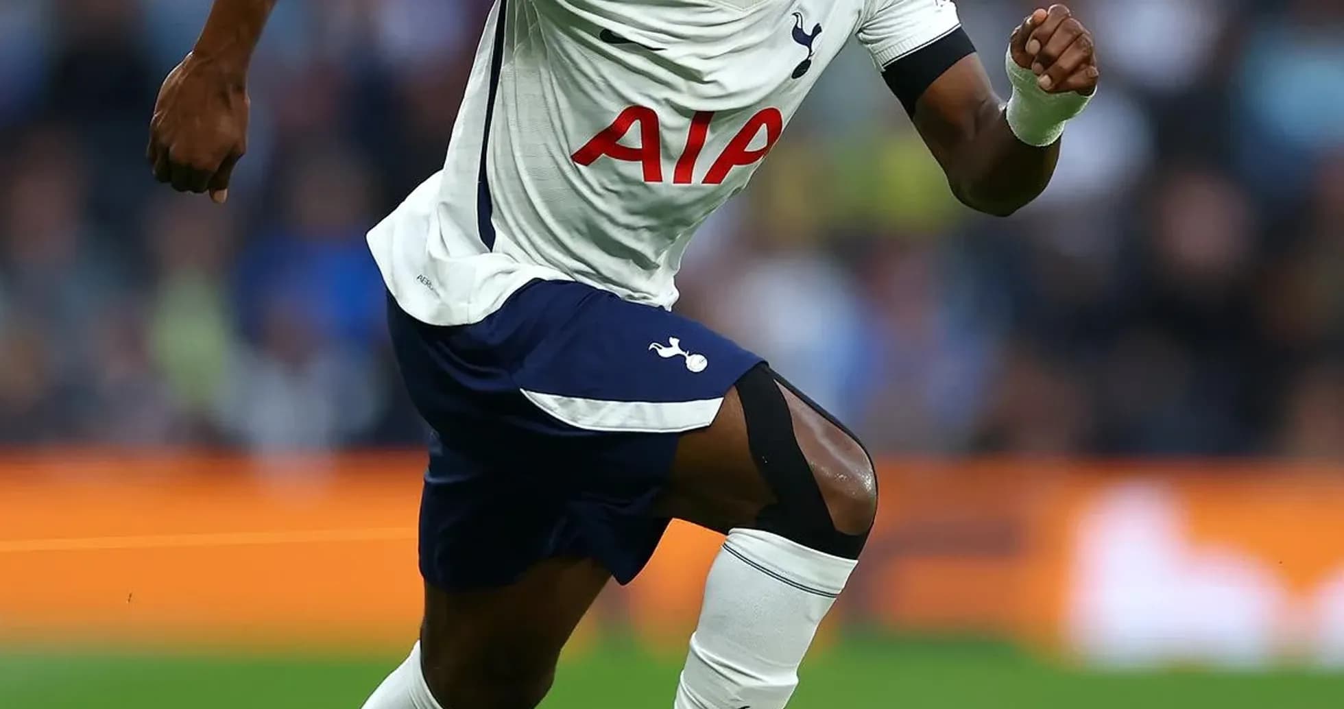 Tottenham player sprinting towards the ball on field Tottenham player sprinting towards the ball on field