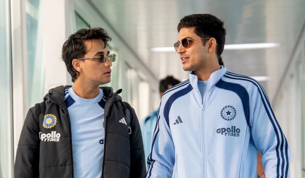 Two players walking in team tracksuits at venue Two players walking in team tracksuits at venue