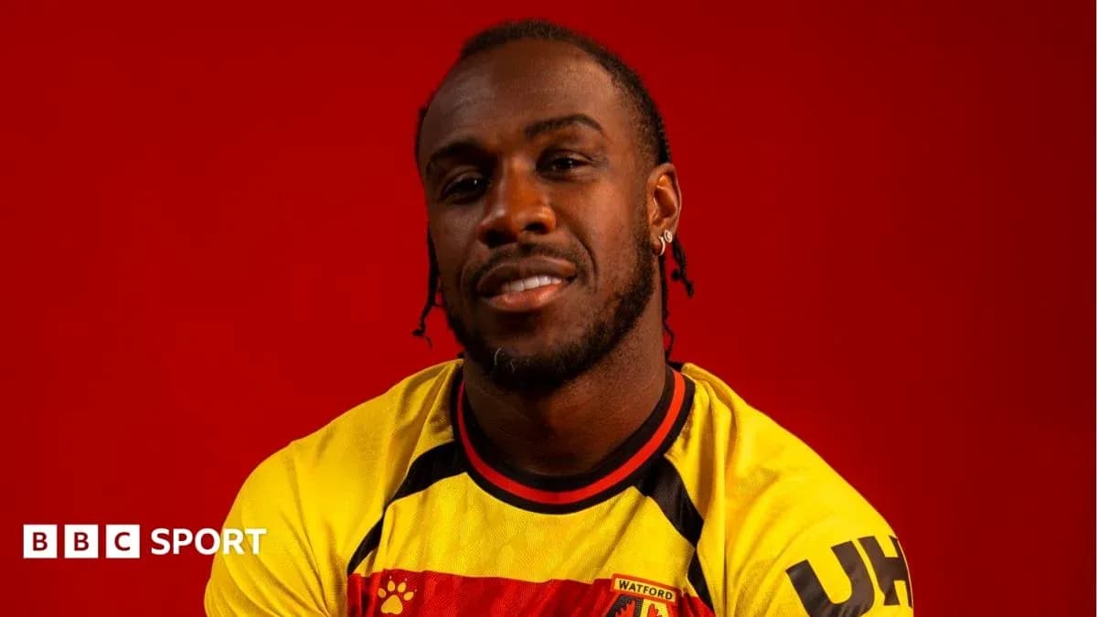 Player wearing Watford FC jersey against red background Player wearing Watford FC jersey against red background
