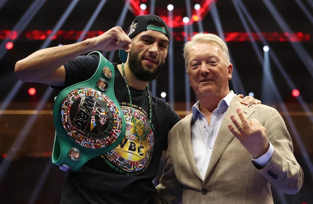 Boxer celebrating with championship belt and promoter Boxer celebrating with championship belt and promoter