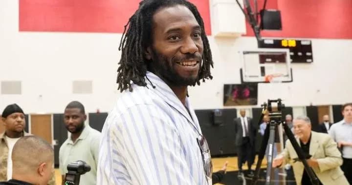 Former player at event with attendees in background Former player at event with attendees in background