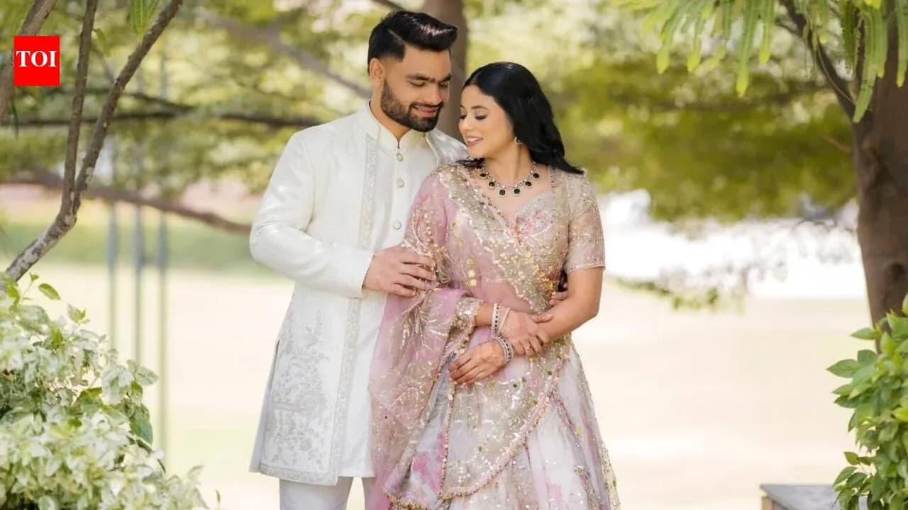 Couple posing together in traditional attire outdoors Couple posing together in traditional attire outdoors