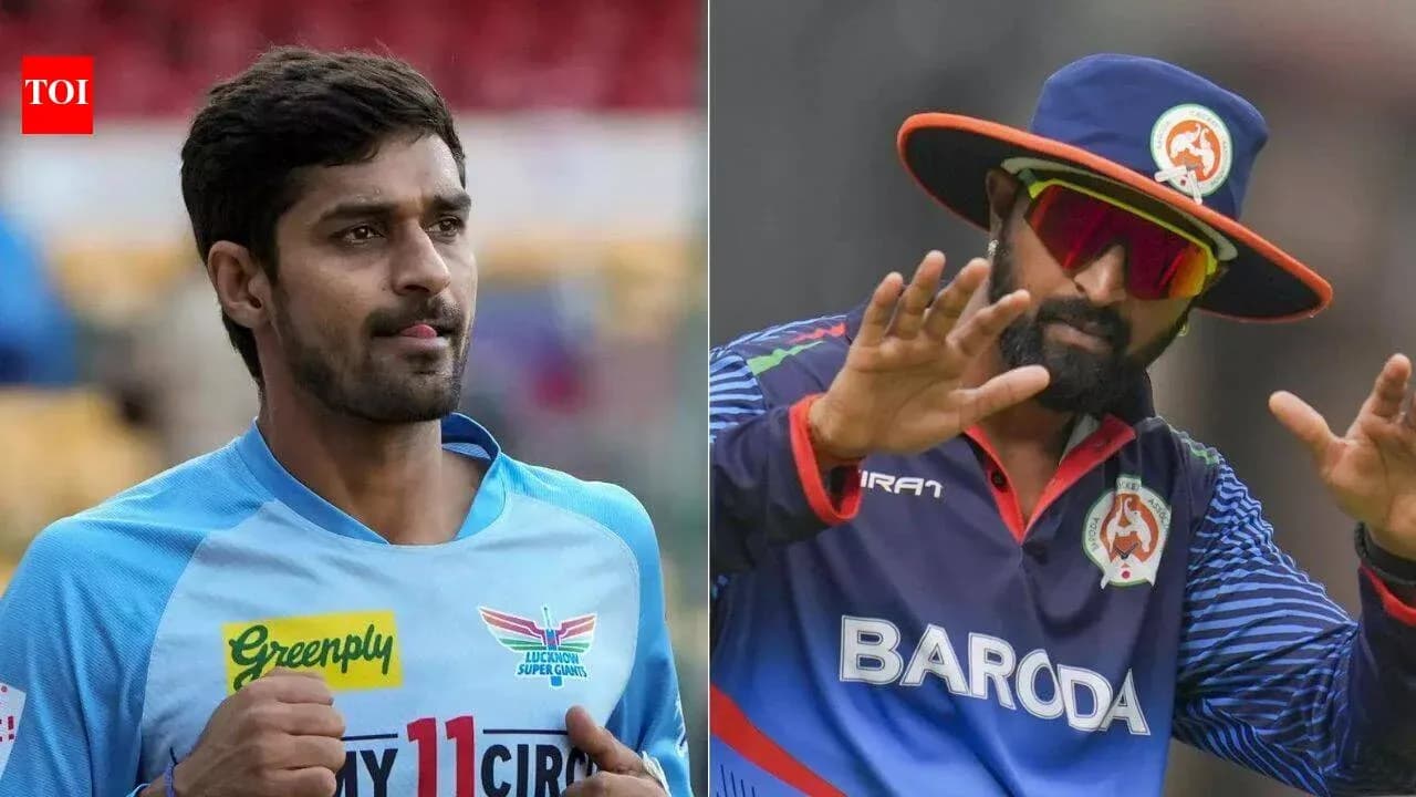 Two cricket players in team uniforms posing Two cricket players in team uniforms posing