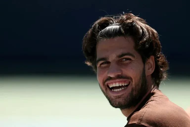 Tennis player smiling during a practice session Tennis player smiling during a practice session