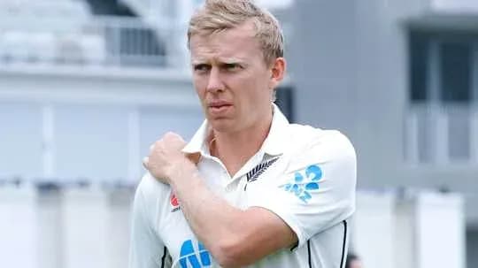 Cricketer adjusting shoulder during practice session Cricketer adjusting shoulder during practice session