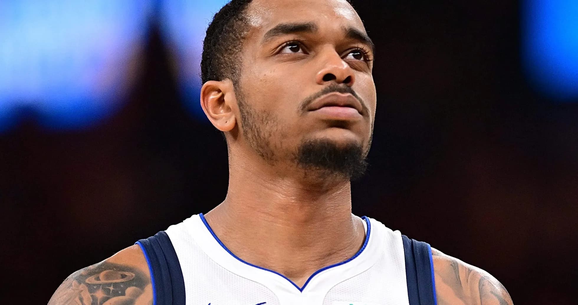 Player in Dallas Mavericks jersey looking upward Player in Dallas Mavericks jersey looking upward