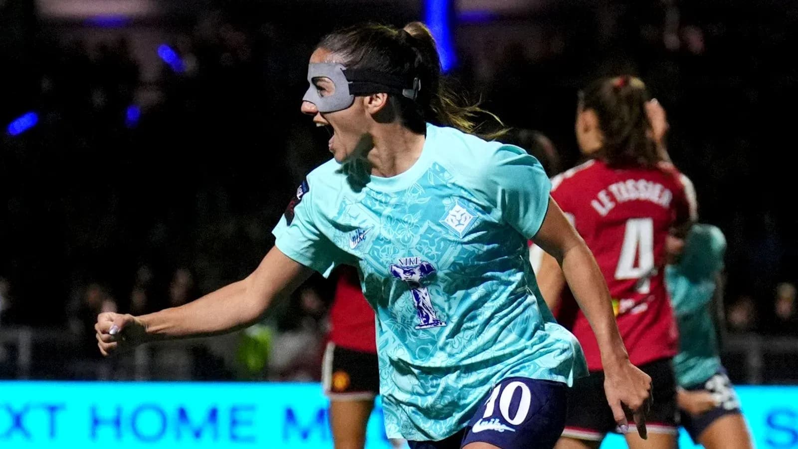 Player celebrating a goal with a mask on Player celebrating a goal with a mask on