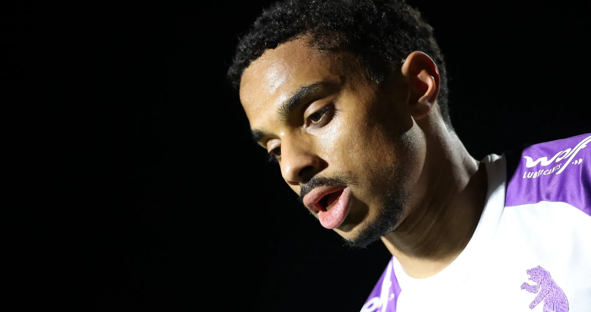 Player with focused expression during post-match interview Player with focused expression during post-match interview