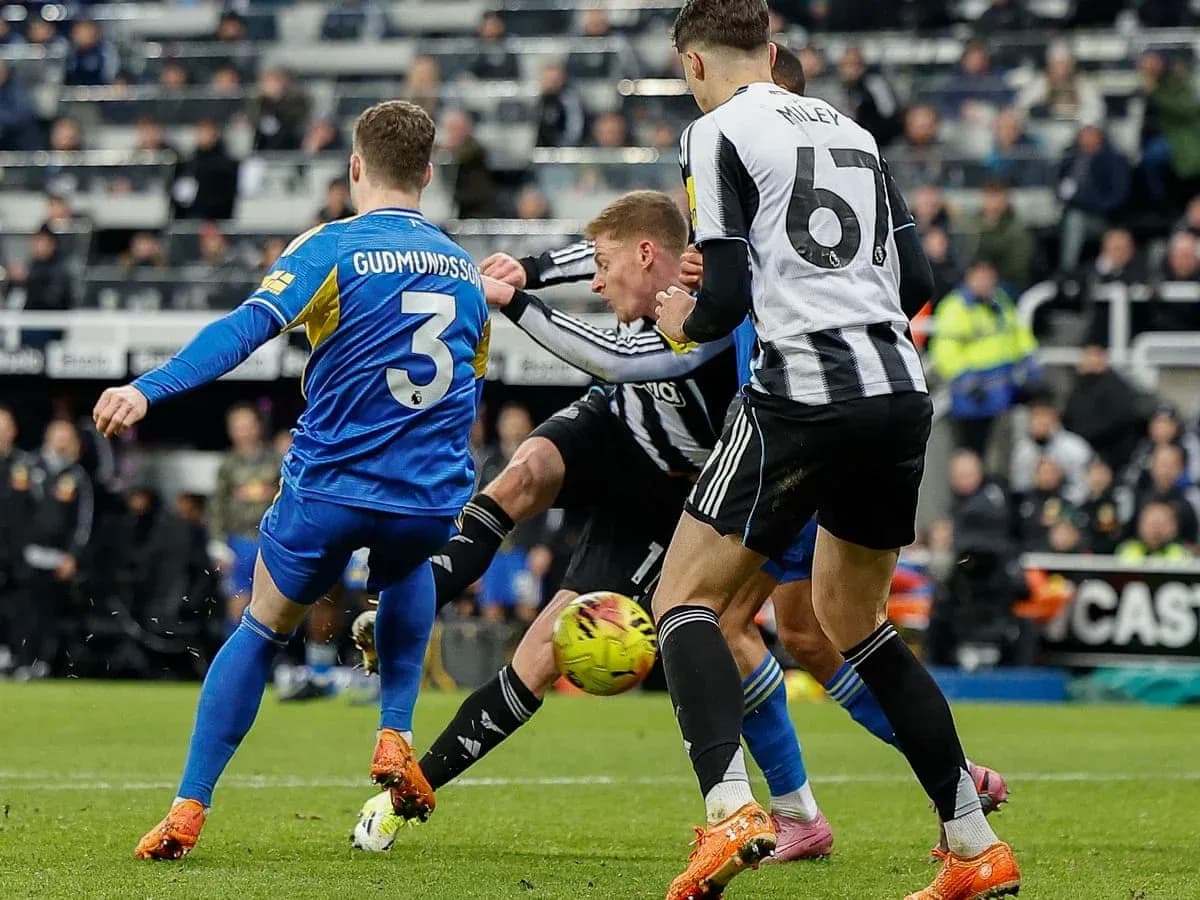 Leeds player tackles Newcastle opponent during match Leeds player tackles Newcastle opponent during match