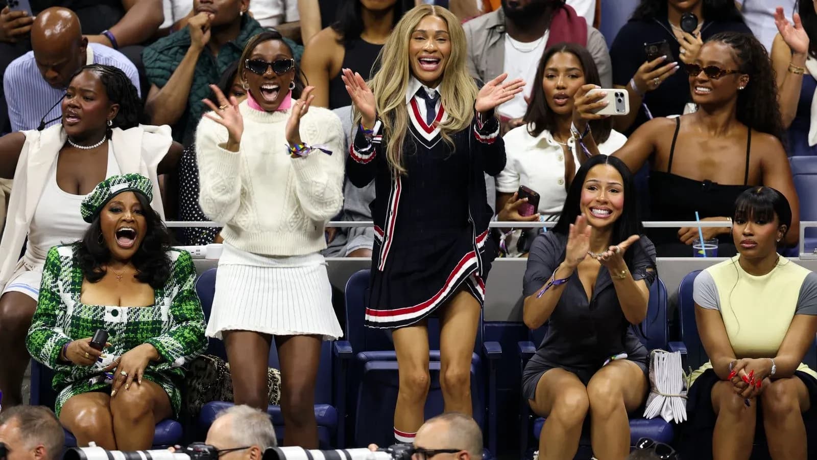Fans celebrating in stands during tennis match Fans celebrating in stands during tennis match