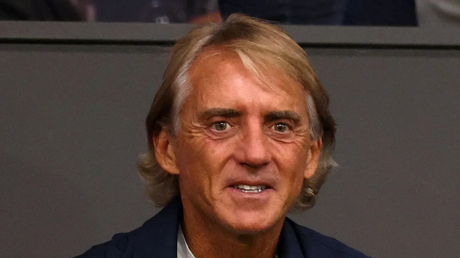 Coach sitting in the stands during a match Coach sitting in the stands during a match