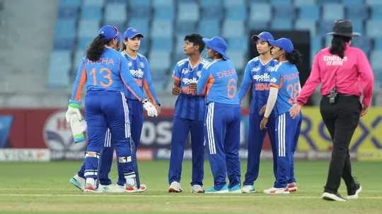 Indian women's cricket team huddling on field Indian women's cricket team huddling on field