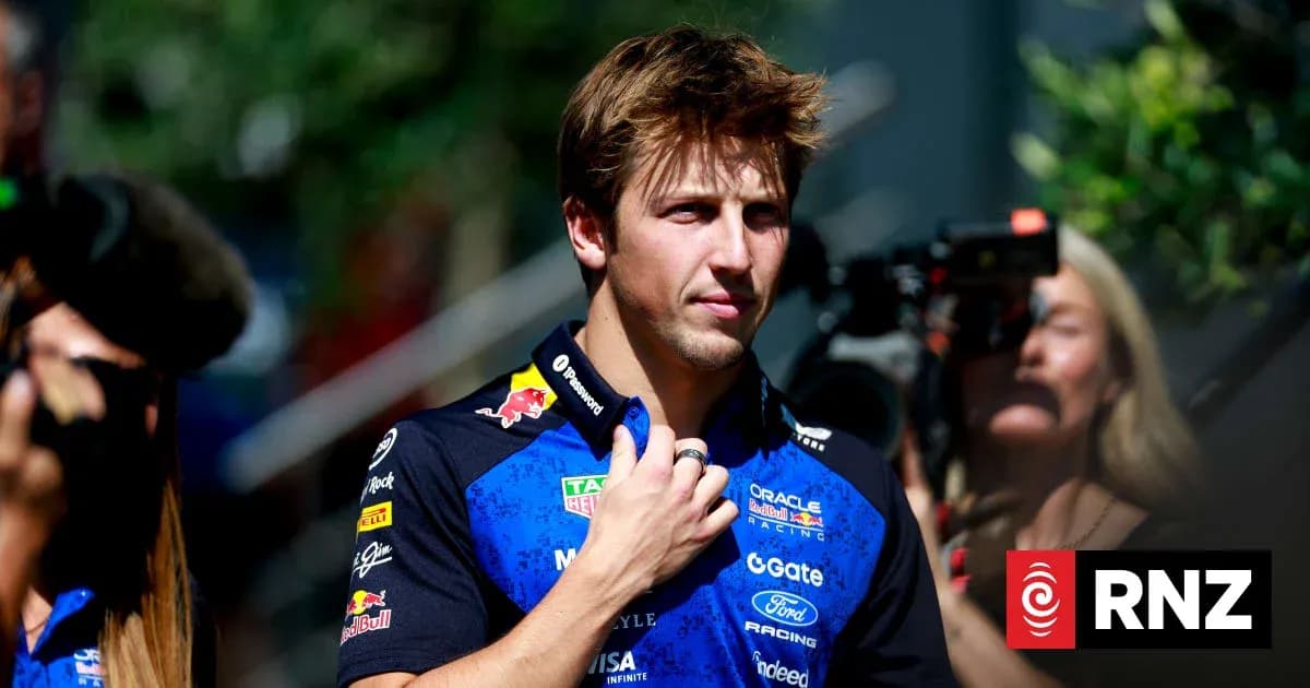 Driver in team uniform during media event Driver in team uniform during media event