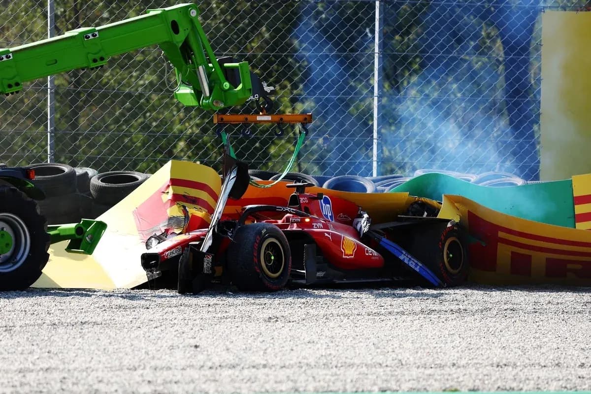 Damaged Ferrari F1 car being lifted from barriers Damaged Ferrari F1 car being lifted from barriers