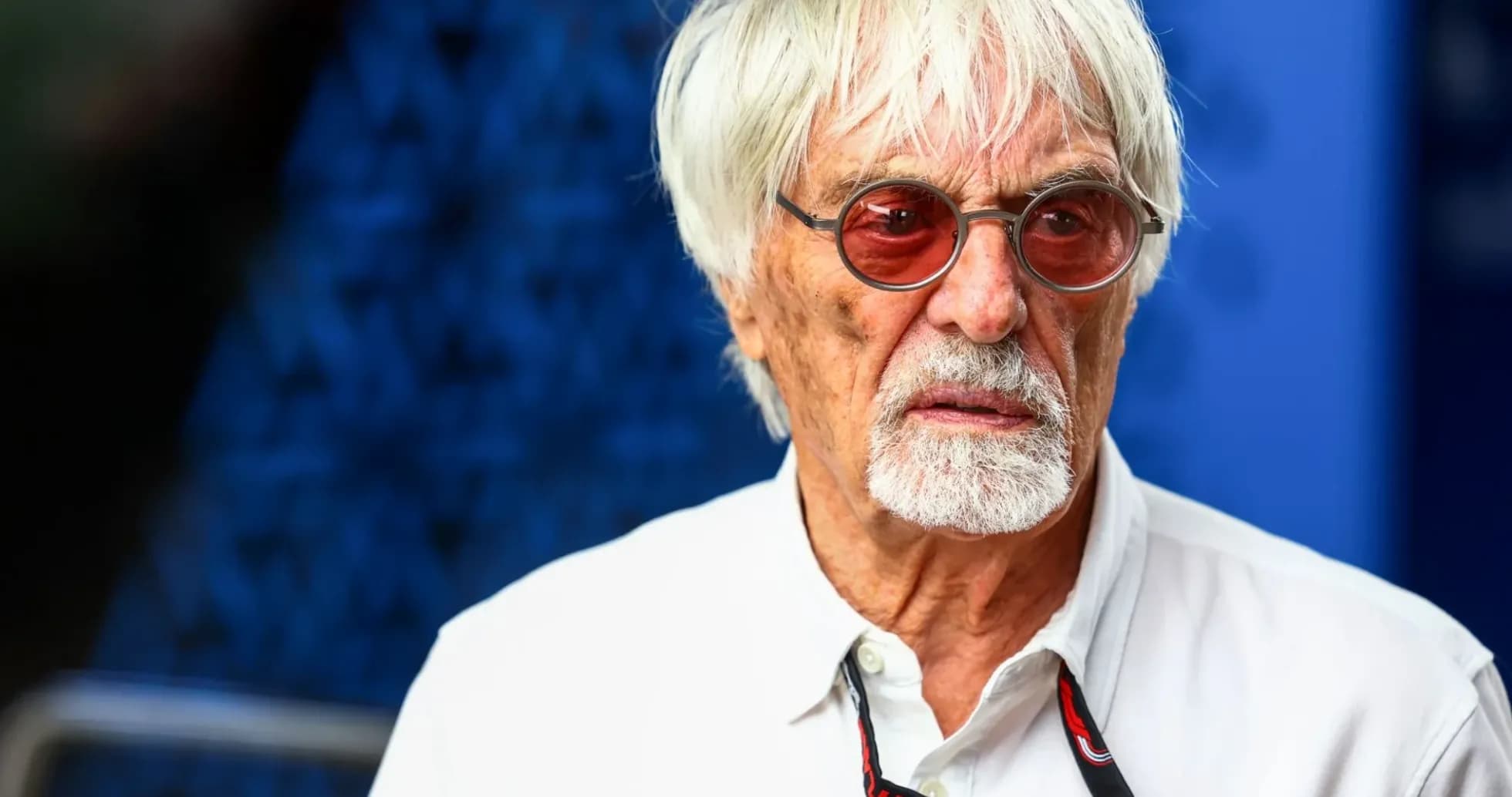 Man with white hair and sunglasses, serious expression Man with white hair and sunglasses, serious expression