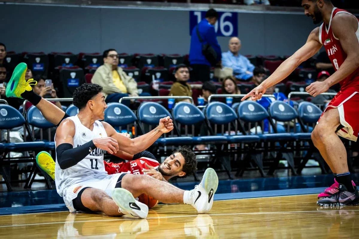 Two basketball players on the court after a fall Two basketball players on the court after a fall