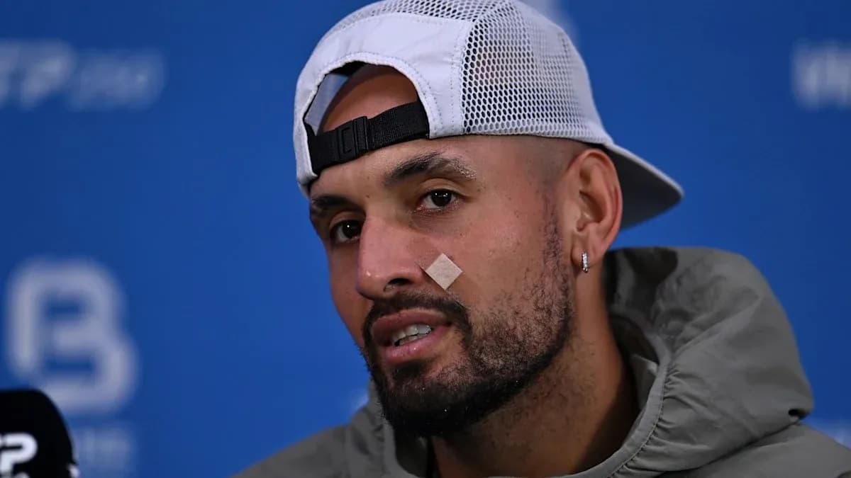 Athlete speaking at press conference with bandage on face Athlete speaking at press conference with bandage on face