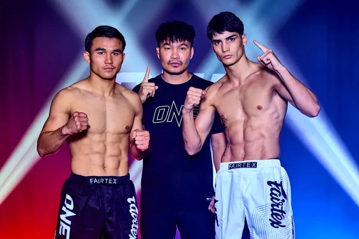 Two fighters posing with a coach before match Two fighters posing with a coach before match