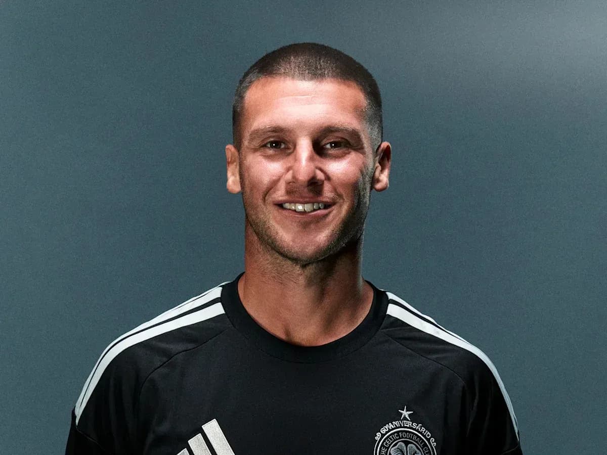 Player smiling in team training kit against backdrop Player smiling in team training kit against backdrop