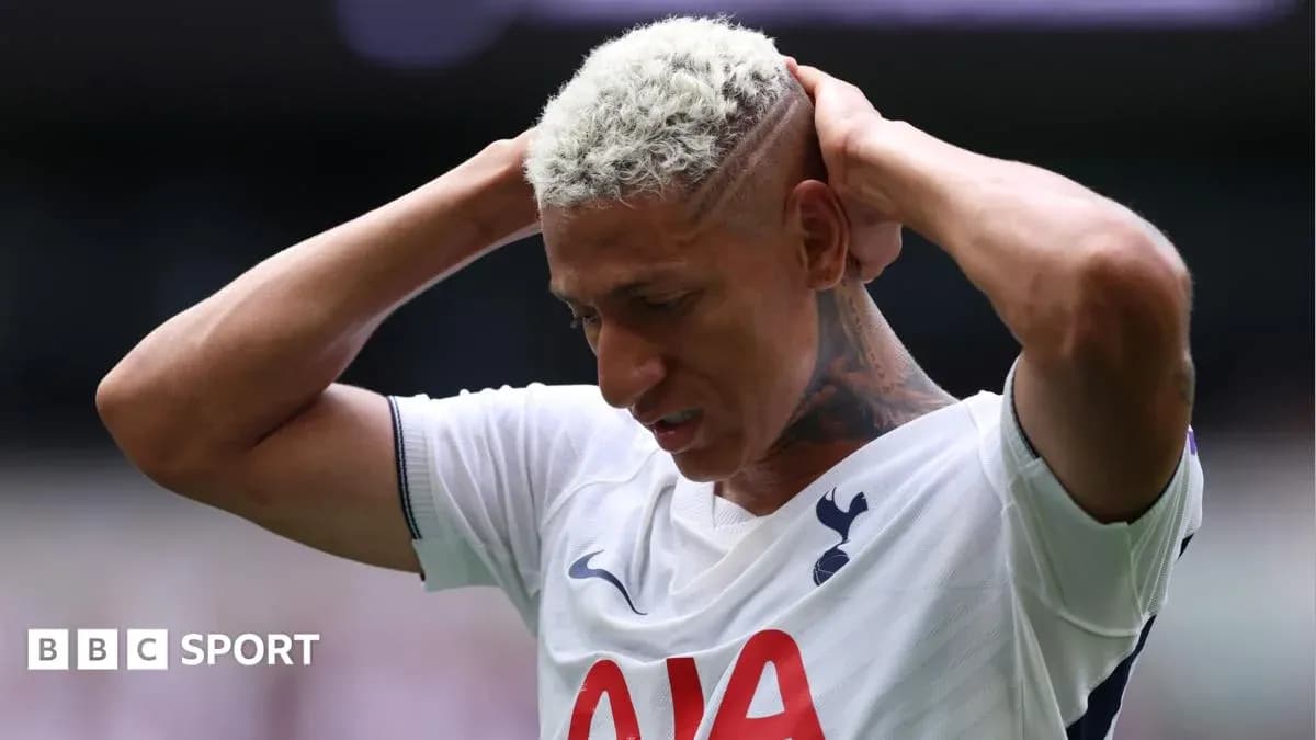 Player holding head during match, wearing Tottenham jersey Player holding head during match, wearing Tottenham jersey