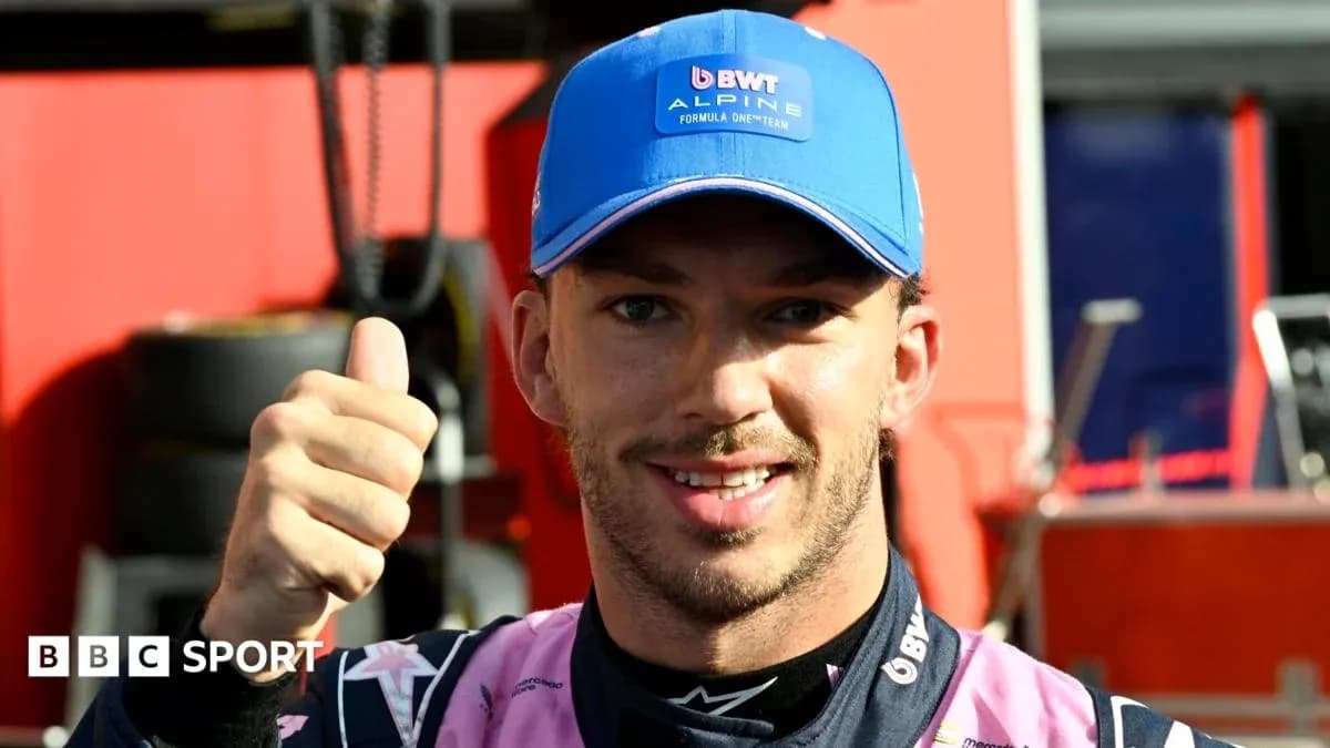 Driver giving thumbs up in team garage Driver giving thumbs up in team garage