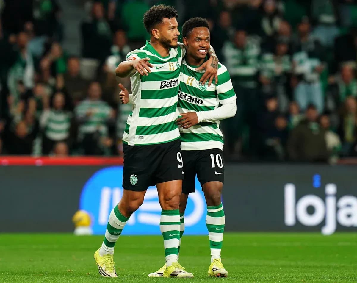 Two players celebrating on the pitch in team jerseys Two players celebrating on the pitch in team jerseys