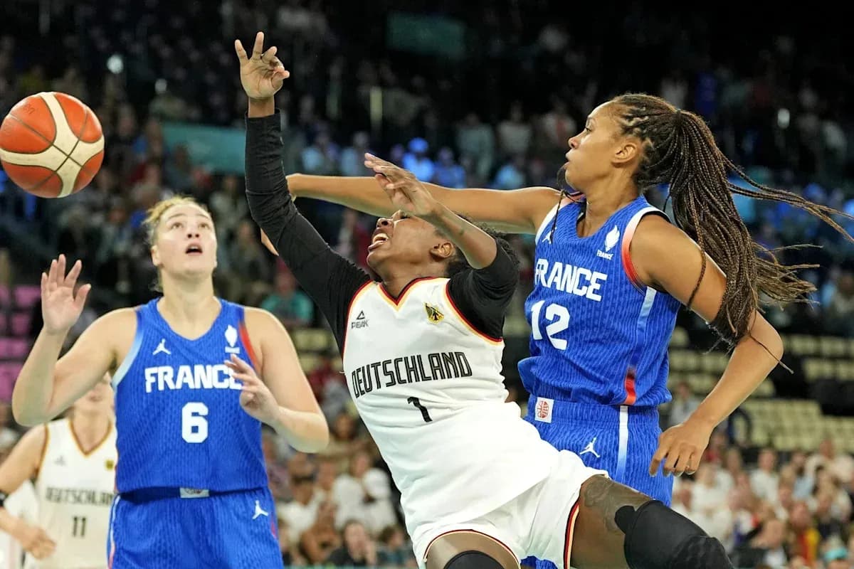 Players contesting for the ball during a basketball match Players contesting for the ball during a basketball match